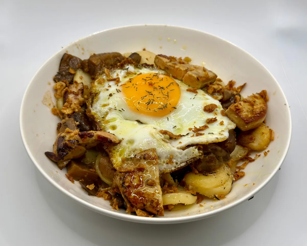 Patatas confitadas con huevo, setas y foie de la carta de raciones